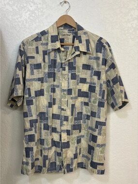 Cooke Street Honolulu blue and beige Hawaiian shirt with tropical leaf pattern.